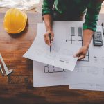 Male engineer drawing architectural plans Engineer sketching con